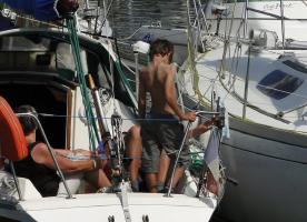 2011 - 12th album - Golden beach boy shirtless on his boat in the port