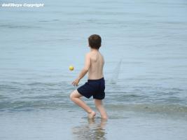2016-088 Beach boy in the sea with blue short and tennis ball