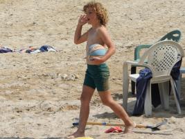 2017-322 Beach boy curly blond hair and his friend playing with his ball