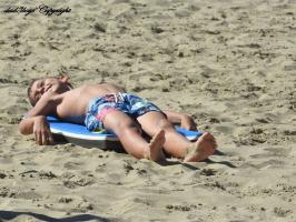 2016-162 Beach boy lying on his paddle