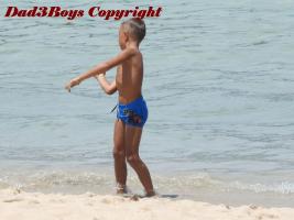 2017-20 Boy in speedo throwing sand in the sea