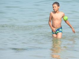 2017-347 Arab Beach boy in the sea playing with a green ball