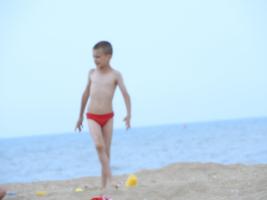 2018-054 Boy red and blue speedo walking on the beach