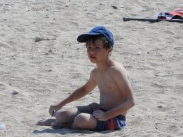 2018-083 Boy sit on the beach