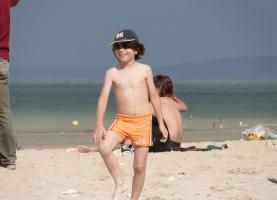 2011 - 23rd album - Wonderful smiling little shirtless beach volley player among adults...