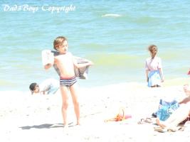 2017-51 Beach boy drying himself. Whom can help ?
