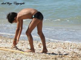2016-176 Beach boy making a mini hill of sand