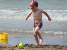 2017-261 Beach boy in red cap and swimsuit