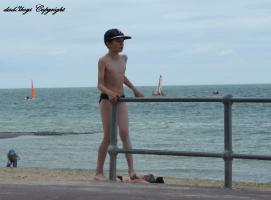 2016-094 Brother in speedo and sister on the bars in front of the beach