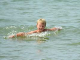 2017-302 Little blond beach boy swiming in the sea and coming out