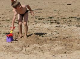 2011 - 28th album - Little beach boy in speedo building a castel