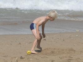2011 - 45th album - Cute blond beach boy in swimsuit building a sand castle