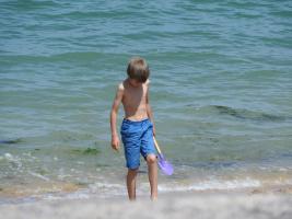 2018-087 Boy in blue short digging on the beach