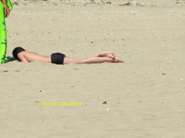 2017-84 Beach boy lying down on the sand