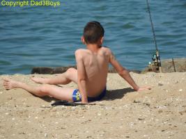 2017-122 Ficher beach boy sit and lying on the sand
