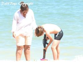 2017-50 Beach boy testing a watergun with his ugly legs mom