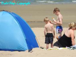 2017-61 Big bro taking care of little bro on the beach near the tent