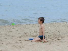 2018-049 Boy kneeled on the beach, and his sister