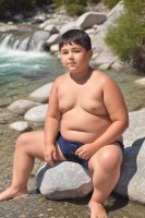 AI GEN chubby boy by a mountain lake