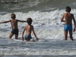 2016-158 Trio of beach boys playing with the waves