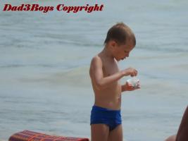 2017-25 Boy in speedo eating ice cream on the beach