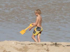 2011 - 80th album - Little blond beach boy wearing a long yellow short with his yellow shovel and some of his friends